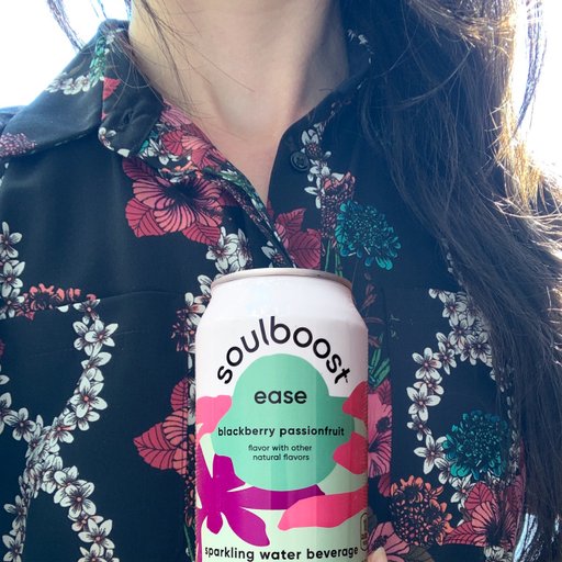 Photo of a woman holding a Soulboost can